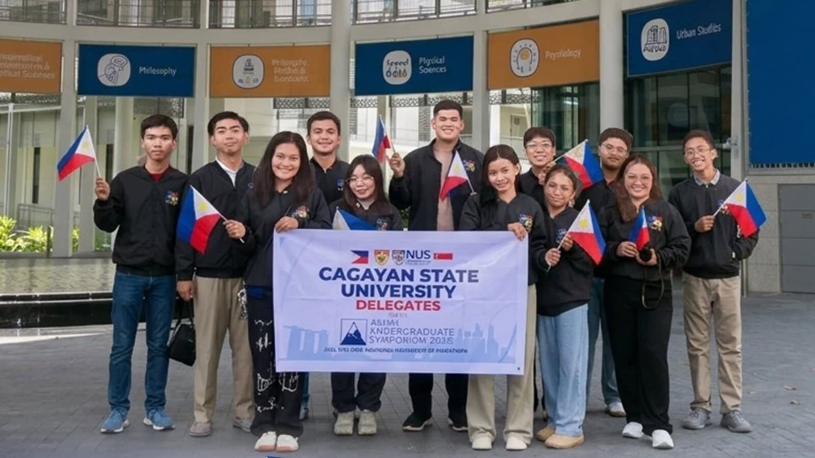 Cagayan State University delegates at NUS for the Asian Undergraduate Symposium 2026, holding Philippine flags and a CSU banner