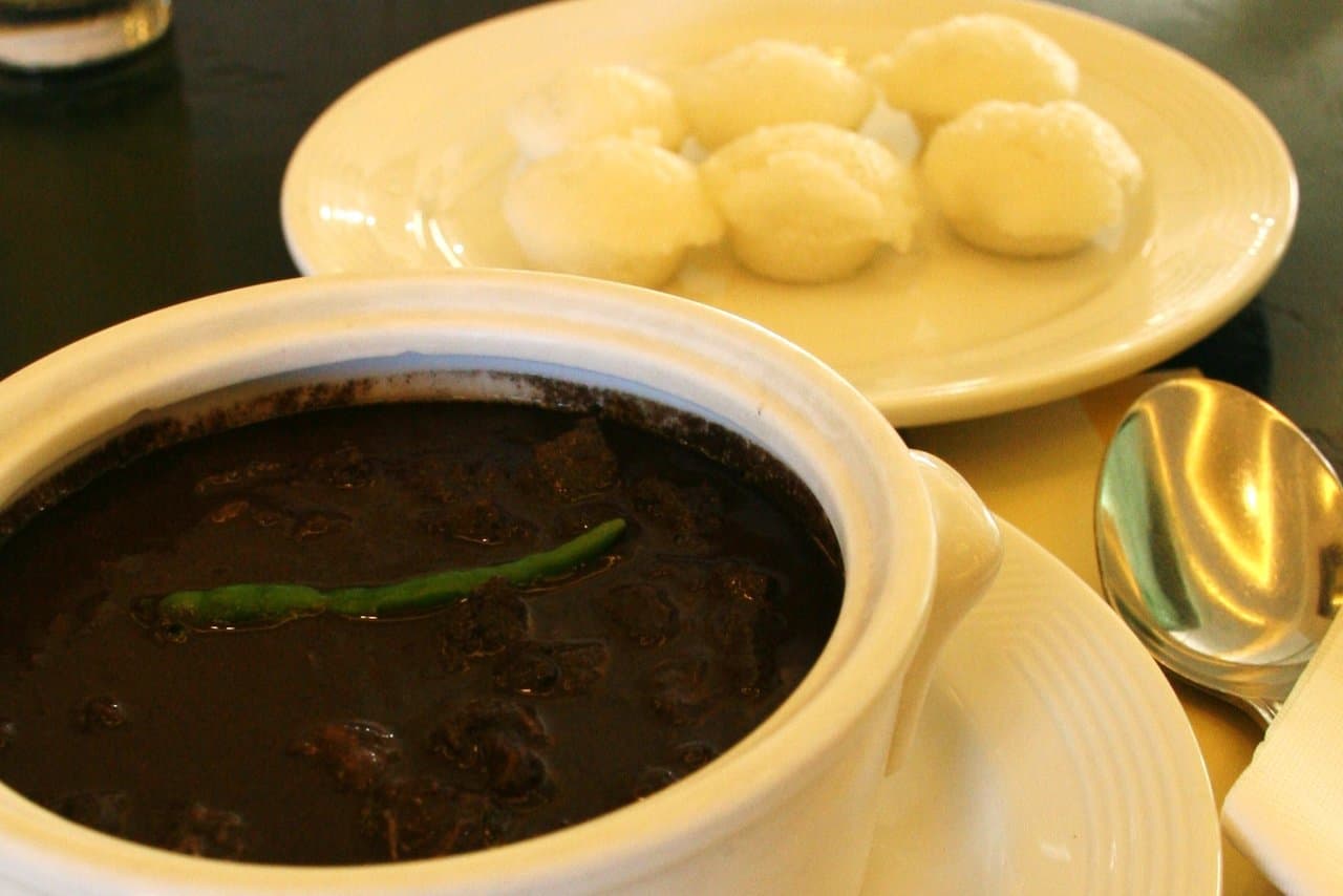Filipino dinuguan with puto on a plate, pork blood stew, the dish at the centre of the Singapore import-ban story