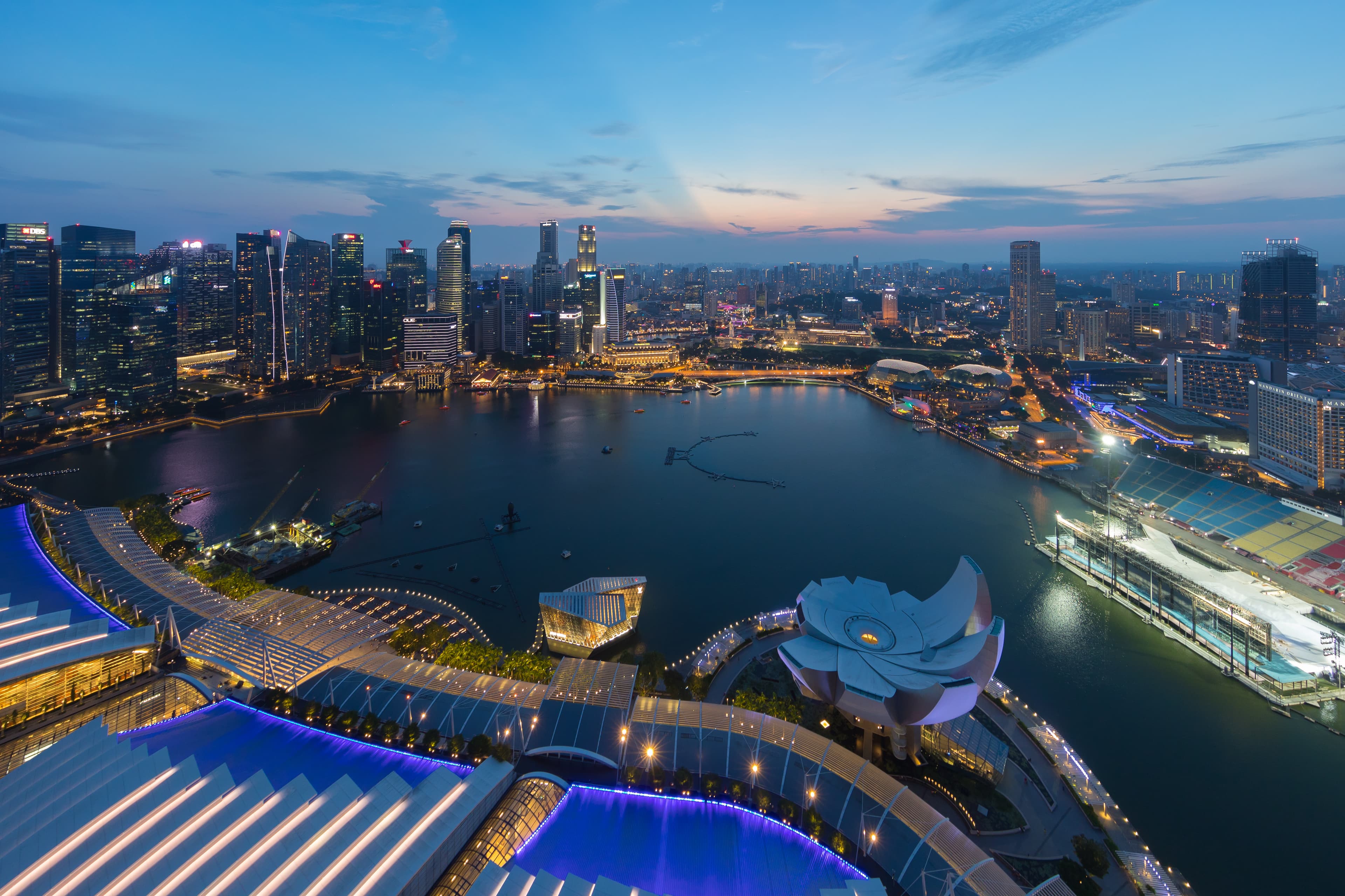 Singapore skyline at dusk over Marina Bay, illustrating a guide to Work Permit cancellation on the myMOM Portal from July 2026