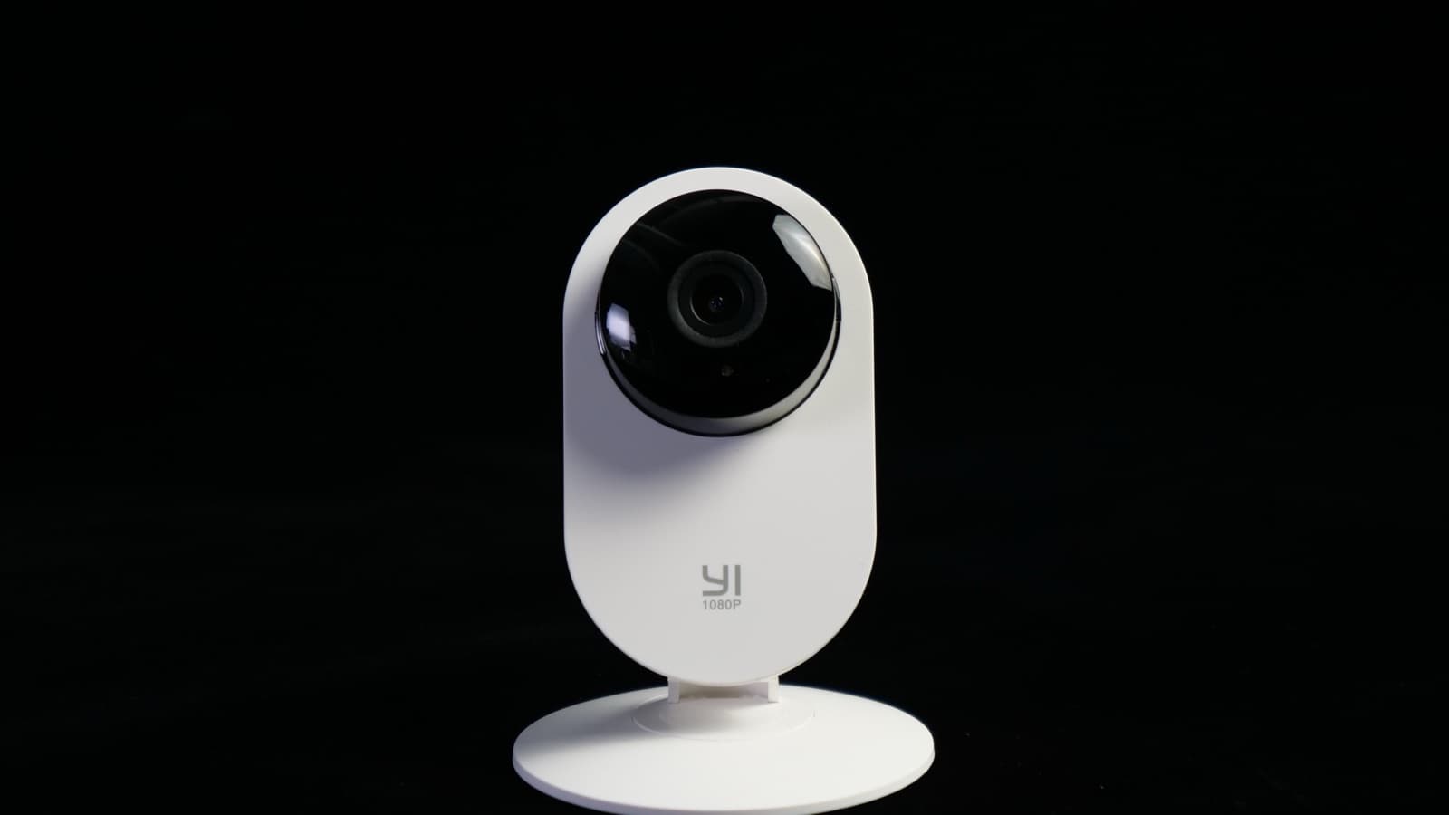 A small white home security camera
