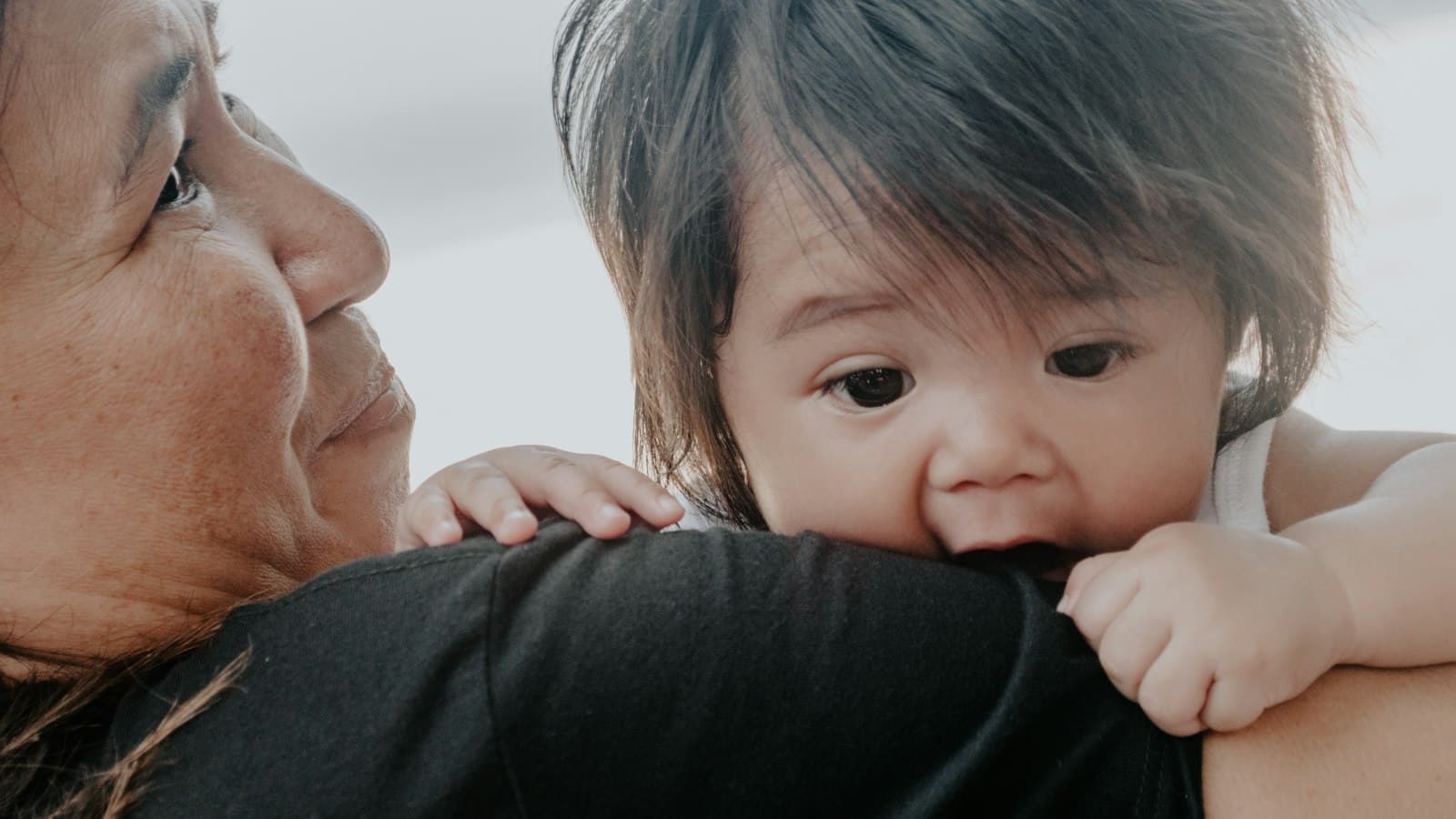 A Filipina lola hugging her toddler grandchild, Samal Island