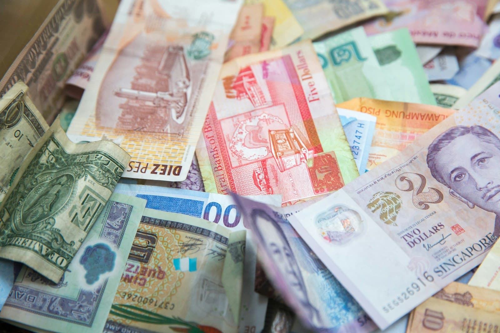 Singapore ten and fifty dollar banknotes laid on a white cloth