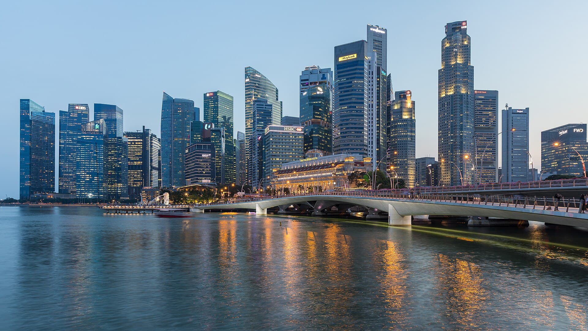 The Singapore Central Business District skyline at dusk, seen across the water near Esplanade Bridge.