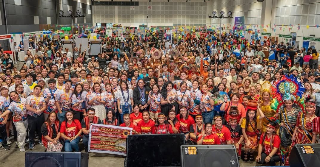The Fiestang Pinoy 2026 committee and cultural performers gather on stage at Suntec for a full group photo, including the Rambak Cordillera contingent in red and Indigenous-inspired costume
