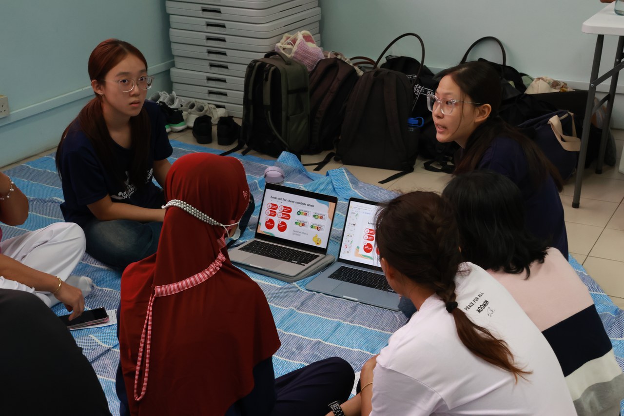 Mental wellness session in progress — volunteers and domestic workers seated together